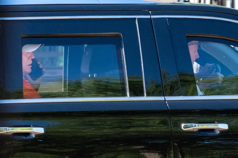President Donald Trump speaks on his cellphone as he departs in his limousine from the White House, Sunday, May 31, 2026, in Washington.