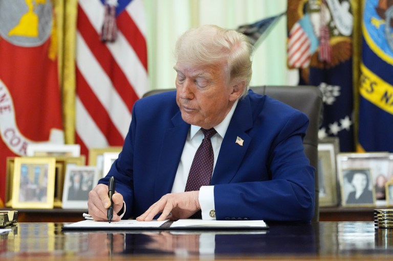 President Donald Trump signs an executive order