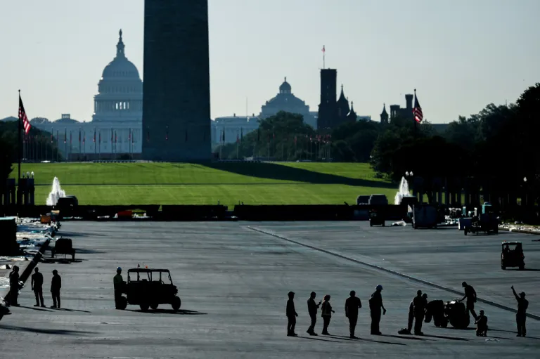 A National Park Service employee, right, gives a thumbs up, as water is being tested in the Lincoln Memorial Reflecting Pool, after it was coated in a blue swimming pool surface ahead of the United States' 250th anniversary, Thursday, June 4, 2026, in Washington. (AP Photo/Julia Demaree Nikhinson)