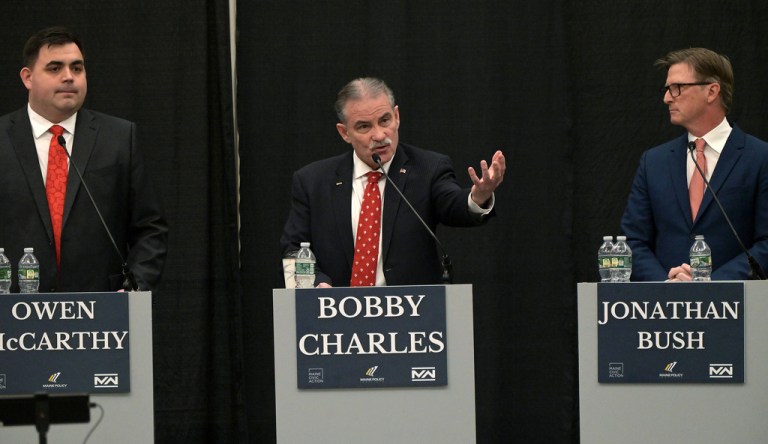 Maine Republican gubernatorial candidate Bobby Charles, center, fields a question from moderator Steve Robinson, editor in chief of The Maine Wire, during a debate of Republican candidates for governor at Cross Insurance Center in Bangor, Maine, Tuesday, March 24, 2026. At left is candidate Owen McCarthy and at right is Jonathan Bush. (Rich Abrahamson/The Central Maine Morning Sentinel via AP)