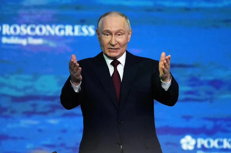 Russian President Vladimir Putin gestures as he arrives to attend a plenary session at the St. Petersburg International Economic Forum.