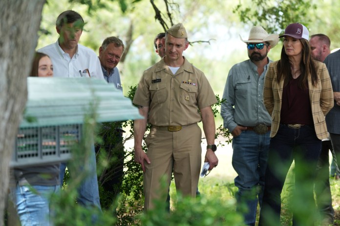 U.S. Agriculture Secretary Brooke Rollins, right, joins other officials, ranchers and media to view a sterile fly dispersal station placed by the U.S. Department of Agriculture to combat the spread of the New World screwworm fly on grounds of a ranch near La Pryor, Texas, Thursday, June 11, 2026.