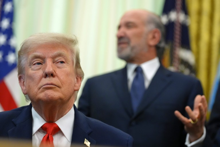 Commerce Secretary Howard Lutnick speaks before President Donald Trump, in foreground, signs a proclamation about the fishing industry, in the Oval Office of the White House, Thursday, June 11, 2026, in Washington. (AP Photo/Jacquelyn Martin)