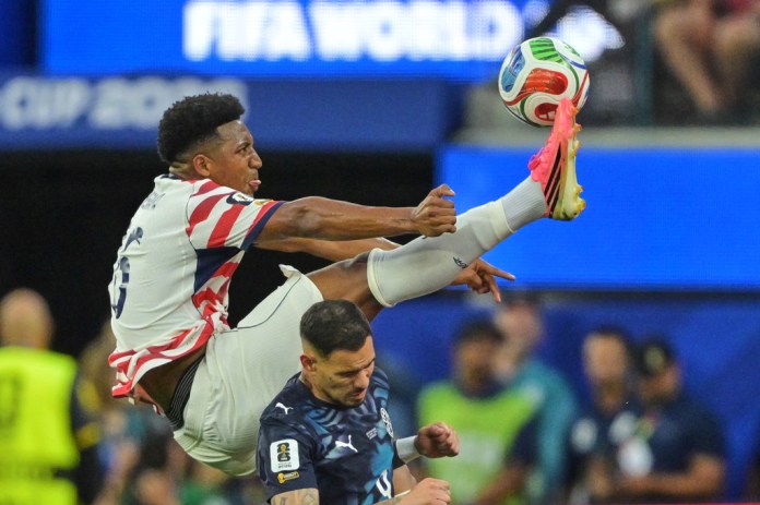 United States' Alex Freeman, top, reaches for the ball over Paraguay's Antonio Sanabria during the World Cup Group D soccer match in Inglewood, Calif., near Los Angeles, Friday, June 12, 2026.