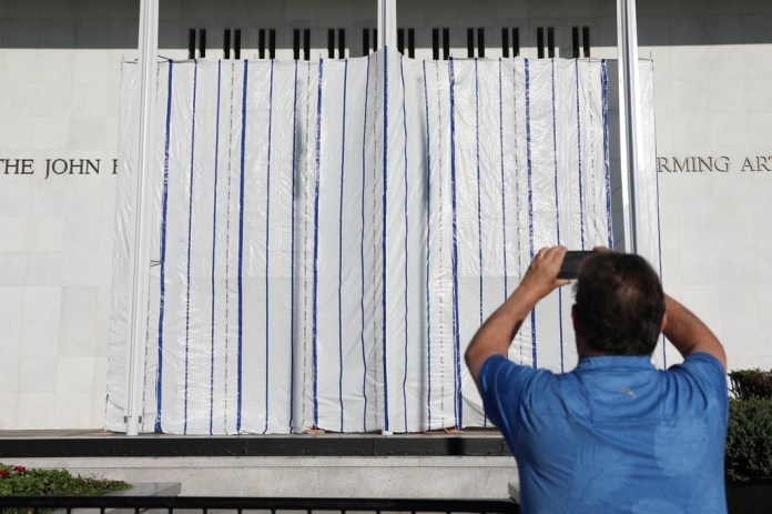 The wall of the John F. Kennedy Center for the Performing Arts is covered in tarp after President Donald Trump's name was removed, in Washington, Saturday, June 13, 2026.