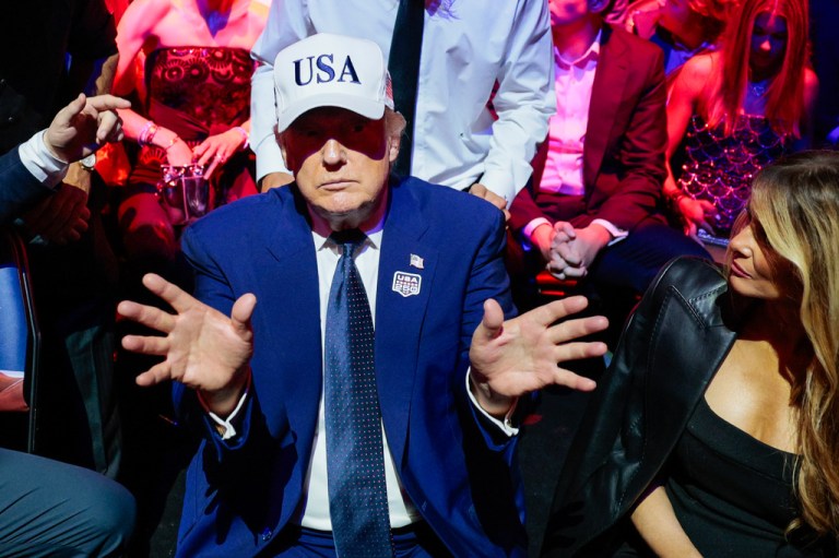 President Donald Trump gestures next to first lady Melania Trump during UFC Freedom 250