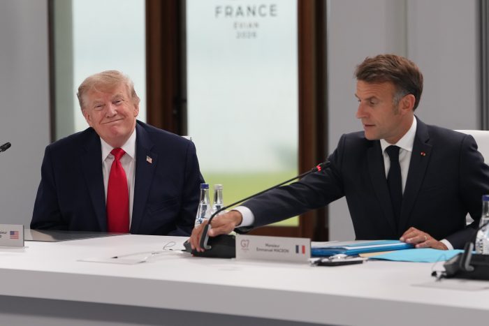 U.S. President Donald Trump participates in a working session with French President Emmanuel Macron, right, other leaders during the G7 summit.
