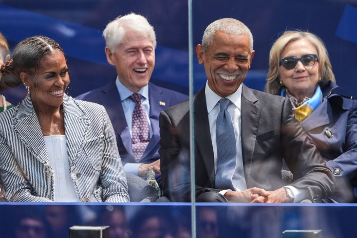 Former President Barack Obama, right, shares a laugh with former first lady Michelle Obama, left, on stage during the dedication ceremony