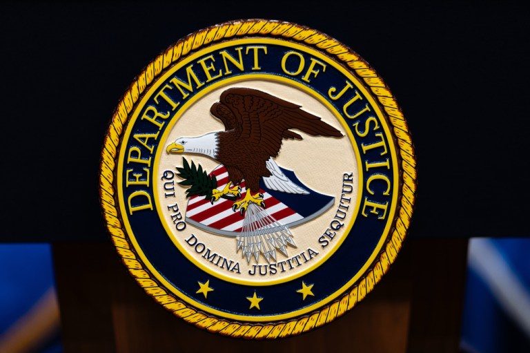 The U.S. Department of Justice logo on a podium.