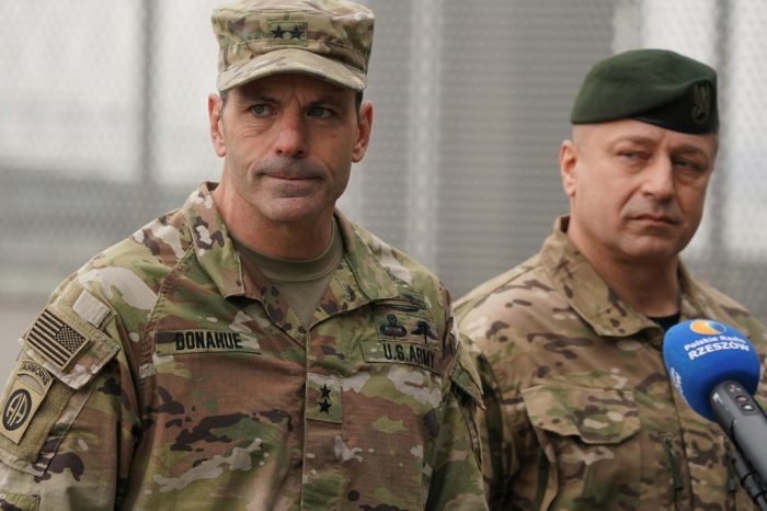 U.S. Army General Christopher Donahue, left, commanding general of the 82nd Airborne Division, and Polish General Wojciech Marchwica speak to journalists after unloading vehicles from a transport plane arriving from Fort Bragg at the Rzeszow-Jasionka airport in southeastern Poland, on Feb. 6, 2022.