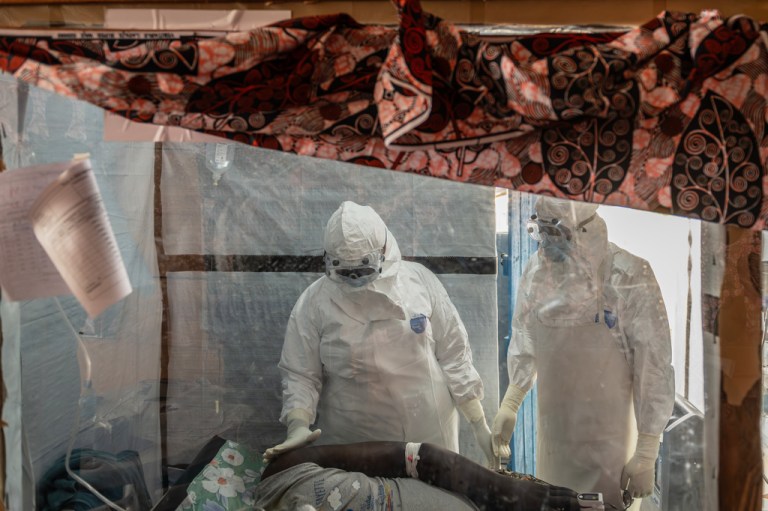 Health workers tend to an Ebola patient