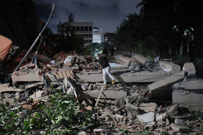 A man jumps on a collapsed building after an earthquake in Caracas, Venezuela