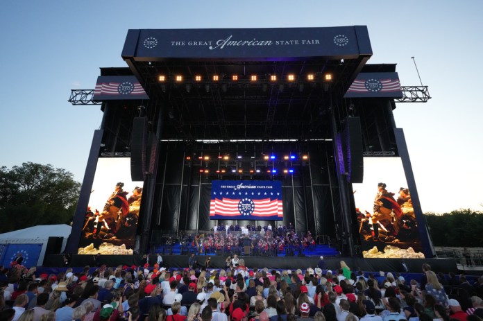 People look at the stage before President Donald Trump speaks at the opening of the Great American State Fair on the National Mall, Wednesday, June 24, 2026, in Washington. 