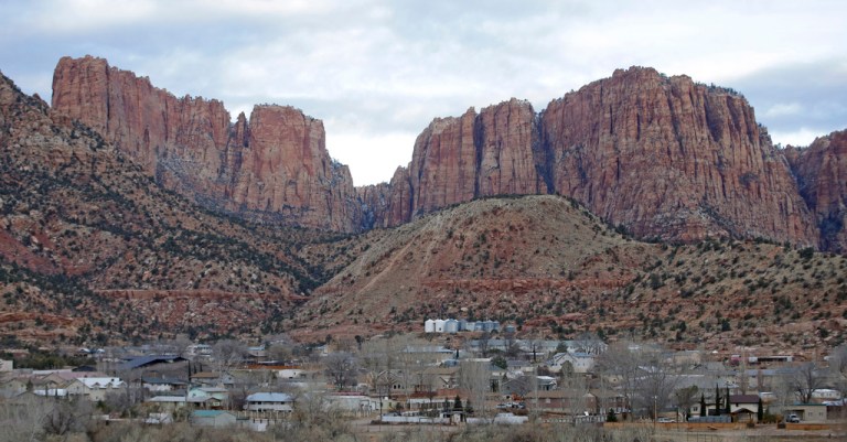 Hildale, Utah, sits at the base of Red Rock Cliff mountains, with its sister city, Colorado City, Ariz., in the foreground, on Dec. 16, 2014. (AP Photo/Rick Bowmer, File)