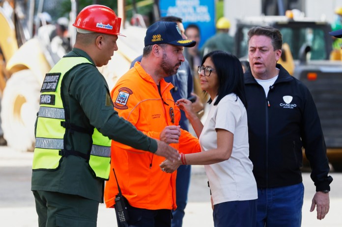 Acting President Delcy Rodriguez visits a quake-damaged area where rescue workers are searching for survivors in Caracas, Venezuela, Friday, June 26, 2026, two days after twin earthquakes struck the country. 