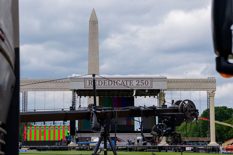 The Washington Monument is visible as workers continue to build out Freedom 250's Great American State Fair