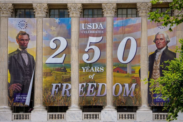 Banners hang from the United States Department of Agriculture (USDA) as workers continue to build out Freedom 250's Great American State Fair infrastructure on the National Mall on May 14, 2026 in Washington, DC. The 16 day World's Fair-scale celebration of America's 250th birthday will run from June 25 to July 10, 2026, uniting all U.S. states and territories. (Photo by Andrew Harnik/Getty Images)