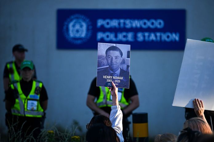 Protestors confront police at Portswood Police station near the location where Henry Nowak died, during a demonstration over the police's handling of the incident, on June 02, 2026 in Southampton, England. Far-right and nationalist groups have actively organised demonstrations and vigils following revelations from the ongoing murder trial of 18-year-old student Henry Nowak. The case involves the fatal stabbing of Nowak in Southampton in December 2025 by Vickrum Digwa. Court details revealed that Digwa falsely claimed to arriving officers that he was the victim of a racist attack, leading responding police to temporarily handcuff the fatally wounded teenager before discovering his injuries. (Photo by Finnbarr Webster/Getty Images)