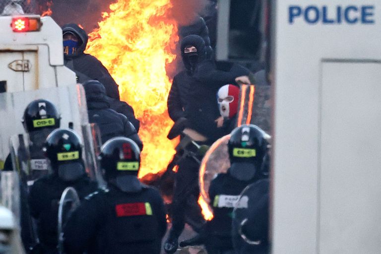 Protesters clash with police blocking their way to a hotel previously believed to house migrants, in Glengormley, north of Belfast, Northern Ireland, on June 10, 2026. Police used water cannon late on June 10 to disperse small crowds who had gathered for a second night in Northern Ireland as UK authorities blamed far-right activists for stoking anger on social media following a brutal stabbing. (Photo by HENRY NICHOLLS / AFP via Getty Images)