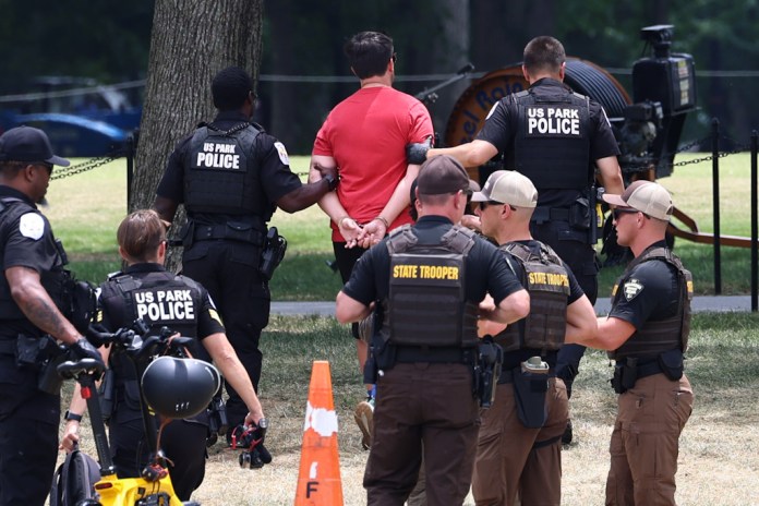 U.S. Park Police arrest someone at the Lincoln Memorial Reflecting Pool. Photography by Graeme Jennings/Washington Examiner