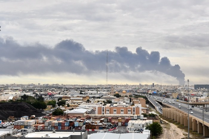 Smoke rises from Kuwait international airport after a drone strike on fuel storage in Kuwait City, Kuwait, Friday, Wednesday, March 25, 2026. (AP Photo)