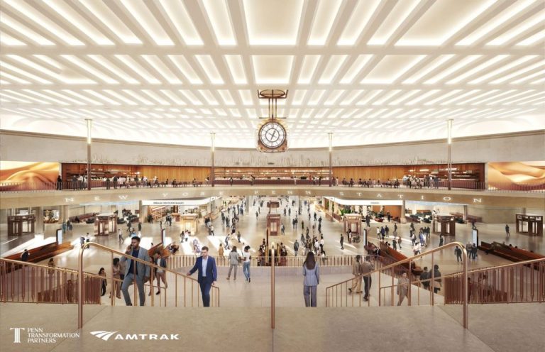 A conceptual interior rendering showing the redesigned main concourse of New York Penn Station under the proposed Amtrak-led redevelopment plan. The image features a dramatic light-filled hall with expanded public space, retail and dining areas, new circulation paths, and a large central clock intended to evoke the grandeur of the original Penn Station while modernizing the transit hub for future rail capacity and passenger demand.(Rendering courtesy of Penn Transformation Partners and Amtrak; designed by PAU.)