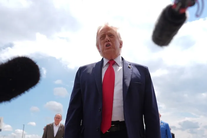 President Donald Trump talks with reporters.