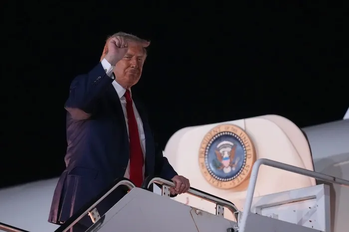 President Donald Trump gestures as he boards Air Force One at John F. Kennedy International Airport in New York, Monday, June 8, 2026. (AP Photo/Mark Schiefelbein)