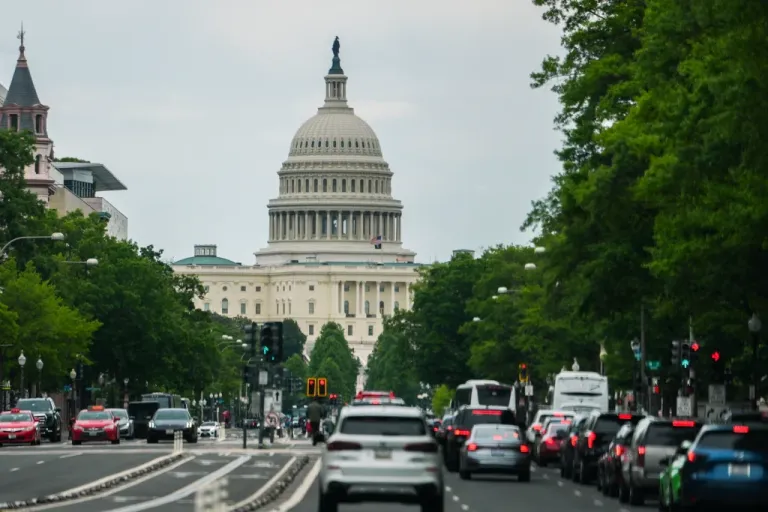 The U.S. Capitol is seen as cars drive on Pennsylvania Avenue.