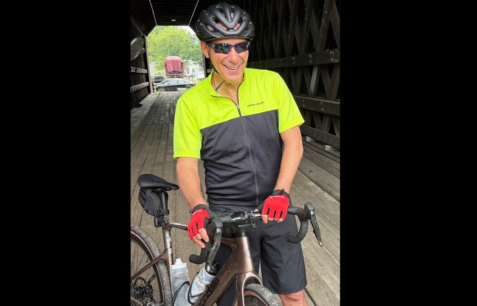 Rahm Emanuel takes a break from a bike ride through New Hampshire, on June 6. (Steven Sloan/AP)
