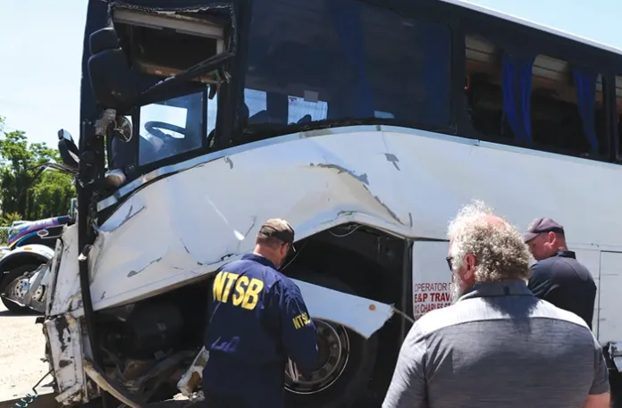 An NTSB investigator examines wreckage on May 30 from the deadly bus crash on I-95 in Stafford County, Virginia. (Courtesy of the NTSB)