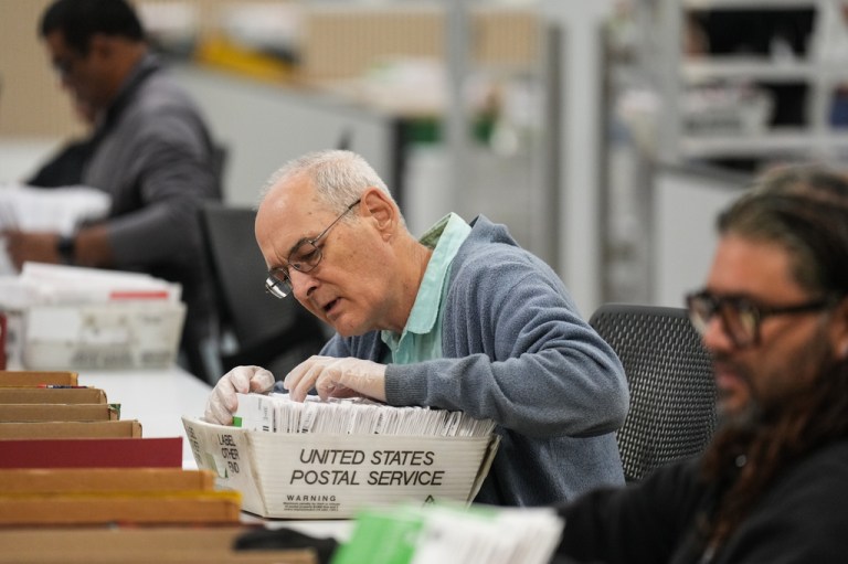 Workers sort ballots the day after California's primary election at the Los Angeles County Ballot Processing Center.