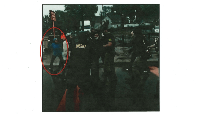 Footage captured Isabel Lopez throwing a softball at responding officers. (Justice Department)