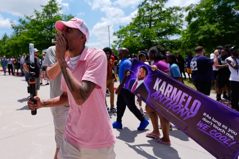 A person walks around announcing the guilty verdict in the Karmelo Anthony trial in front of the Collin County courthouse.