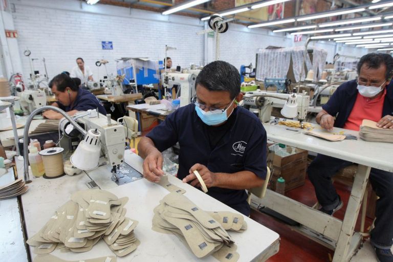Mexican workers in a shoe shop.
