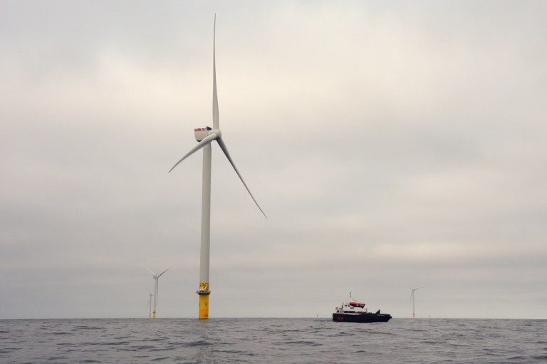 A boat maneuvers near Revolution Wind offshore wind farm off the coast of Rhode Island.