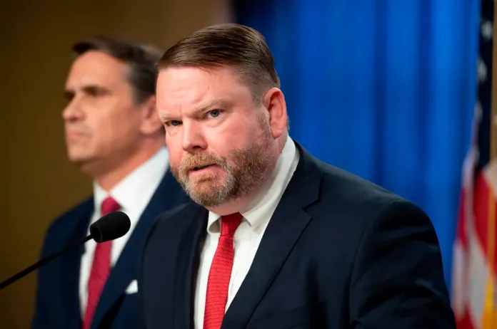 Ellis Boyle, U.S. attorney for the Eastern District of of N.C., right, speaks, while Acting Attorney General Todd Blanche, looks on as they announce that former FBI Director James Comey has been indicted, at the Justice Department in Washington, Tuesday, April 28, 2026. (AP Photo/Cliff Owen)