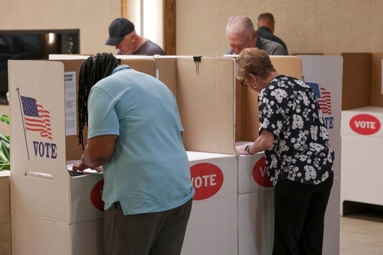 Voters mark ballots at a polling location inside the Shoppes at Northpark mall.