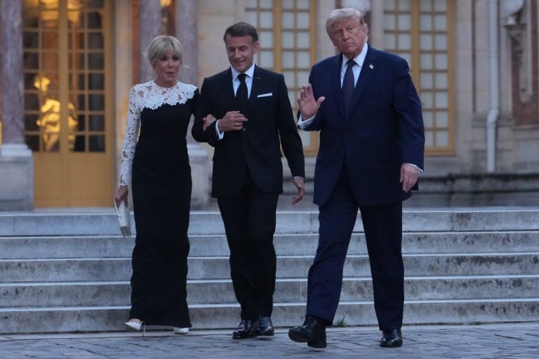 U.S. President Donald Trump is greeted by French President Emmanuel Macron and first lady Brigitte Macron