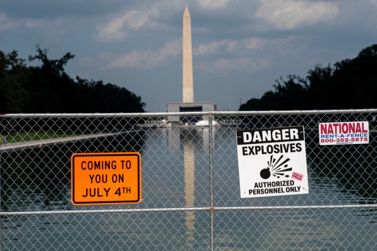 Signage and security fencing warns of explosives along the Lincoln Memorial Reflecting Pool ahead of July 4th events on the National Mall, Wednesday, July 1, 2026, in Washington. (AP Photo/Nathan Howard)