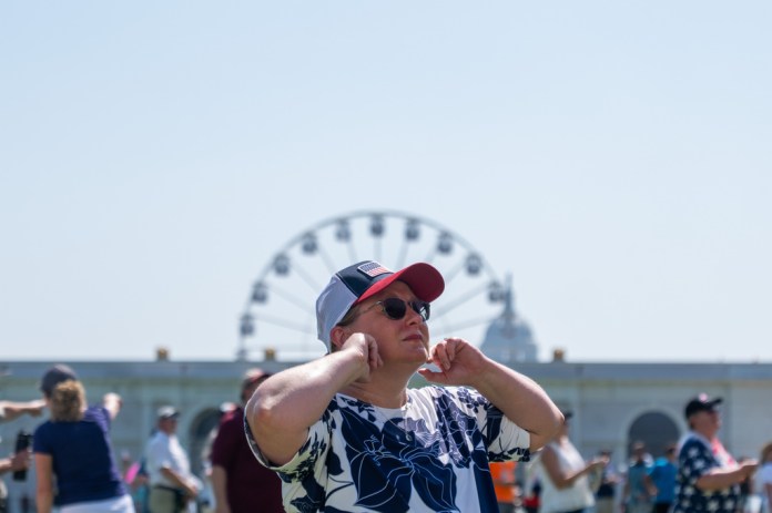 Attendees react to flyovers at the Great American State Fair on the National Mall, Friday, July 3, 2026, in Washington.