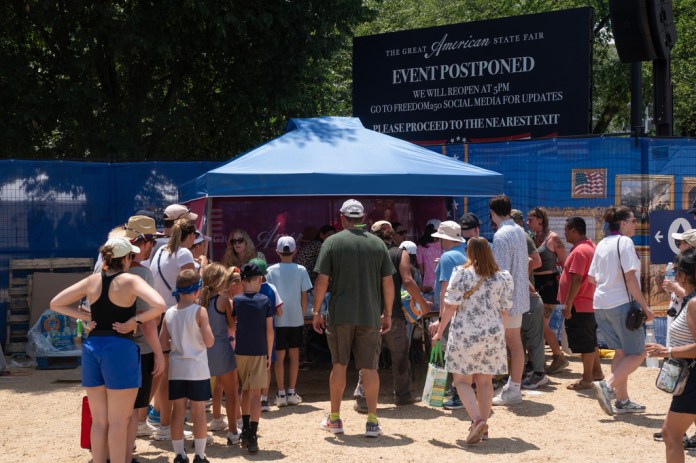 Attendees exit the grounds of the Great American State Fair after the event was closed for the afternoon due to extreme heat on the National Mall, Friday, July 3, 2026, in Washington.