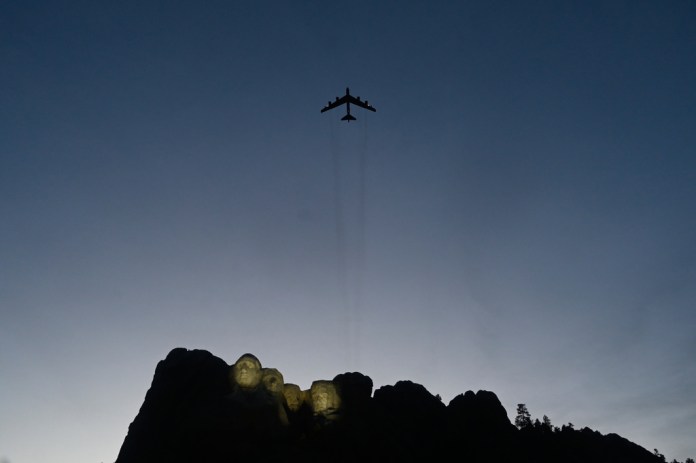 A B-52 plane performs a flyover as Interior Secretary Doug Burgum speaks before President Donald Trump at Mount Rushmore National Memorial, Friday, July 3, 2026, near Keystone, S.D.
