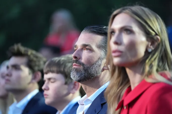Donald Trump Jr., and his wife Bettina Trump, listen before President Donald Trump speaks at Mount Rushmore National Memorial, Friday, July 3, 2026, near Keystone, S.D.