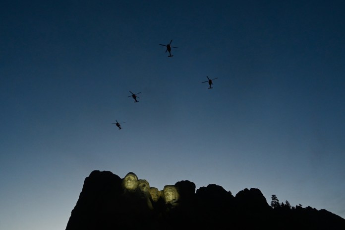 UH-60 Black Hawk helicopters perform a flyover as Interior Secretary Doug Burgum speaks before President Donald Trump at Mount Rushmore National Memorial, Friday, July 3, 2026, near Keystone, S.D.