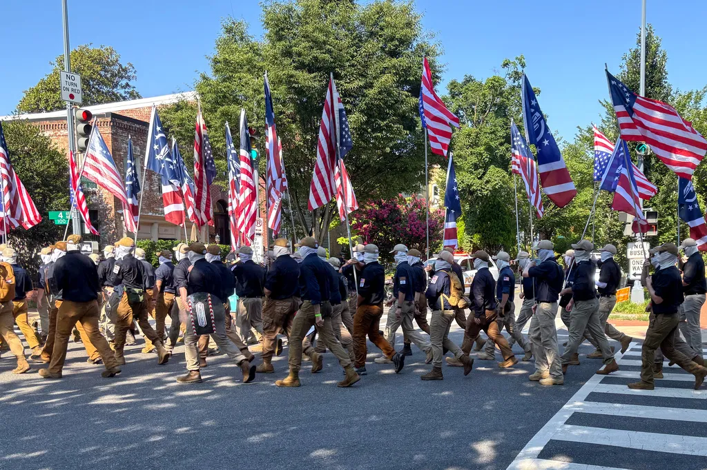 In this image provided by Mark Sherman, members of the group Patriot Front wear masks as they march through Washington before Independence Day events honoring the nation's 250th anniversary, Saturday, July 4, 2026. (Mark Sherman via AP)