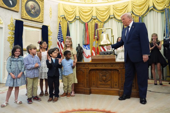 President Donald Trump rings the opening bell for the New York Stock Exchange and the Nasdaq in the Oval Office at the White House, Monday, July 6, 2026, in Washington. (AP Photo/Mark Schiefelbein)