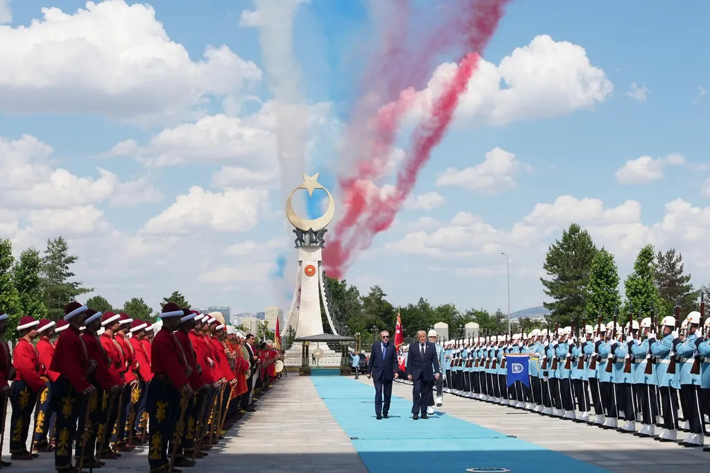 President Donald Trump walks by an honor guard with Turkish President Recep Tayyip Erdogan at the Bestepe Presidential Complex.