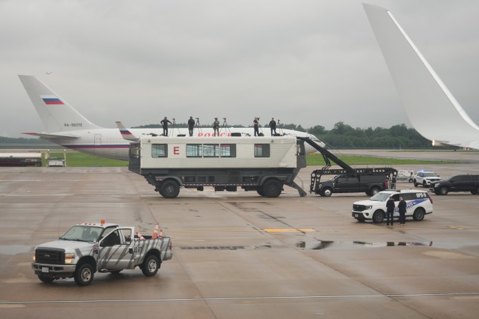 U.S. Secret Service agents keep watch before Vice President JD Vance boards Air Force Two at Dulles International Airport, Wednesday, July 8, 2026, in Dulles, Va., en route to Wisconsin. (AP Photo/Mark Schiefelbein, Pool)