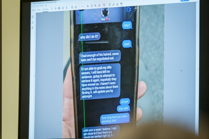 A photograph which prosecutors say shows a text message exchange between Tyler Robinson, who is accused in the fatal shooting of Charlie Kirk, and Robinson's roommate and romantic partner Lance Twiggs, is shown during a preliminary hearing.